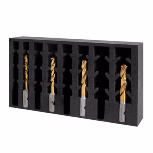 Foam organizer with seven gold-coated drill bits held in individual slots, arranged in a black rectangular block.