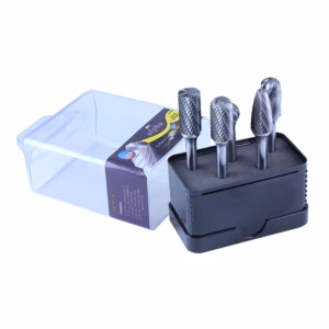 Set of four carbide burr bits in a foam-lined black storage case with a clear plastic lid nearby, for rotary metalworking.