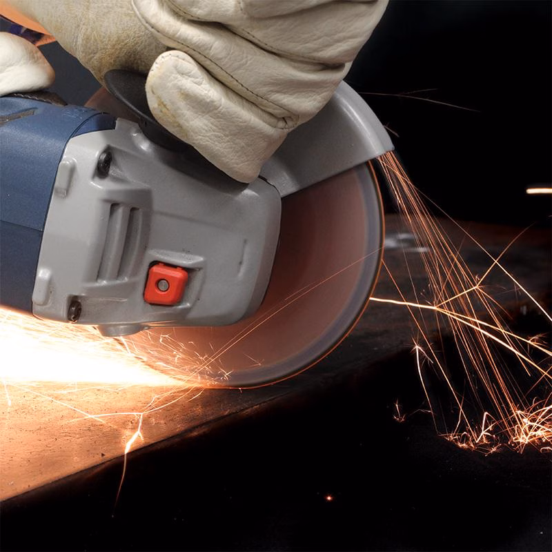 GCDSS18020_3 - Alpha Tools Angle grinder cutting metal, sparks flying as a gloved hand guides the tool.