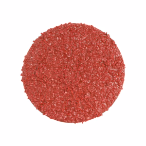 Round raw burger patty coated with red seasoning on a white background.