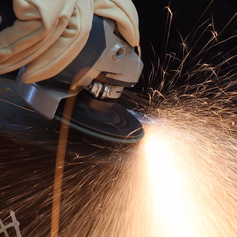 GRFA11536_3 - Alpha Tools Close-up of an angle grinder cutting metal, sending bright sparks in all directions.