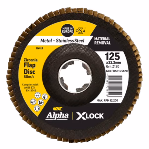 Close-up of a black abrasive flap disc with a yellow label marked Alpha XLock and Made in Europe, showing the central bore and outer abrasive segments.